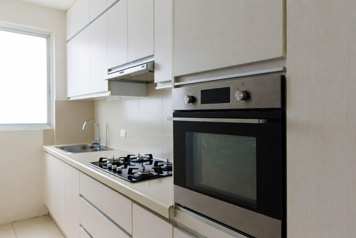 Built-in oven and gas range in a Singapore HDB kitchen.
